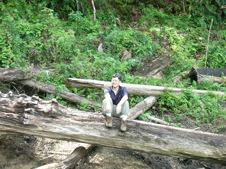Haw Chuan Lim sitting on a log